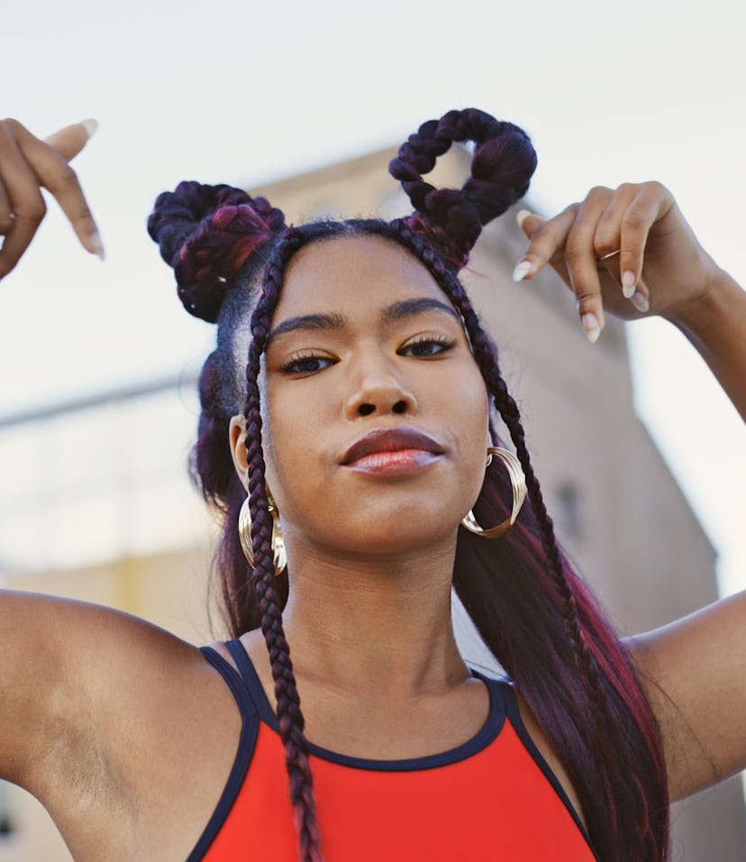 Young woman with her arms in the air, being fiery as one of the three fire signs are Leo, Aries, and...