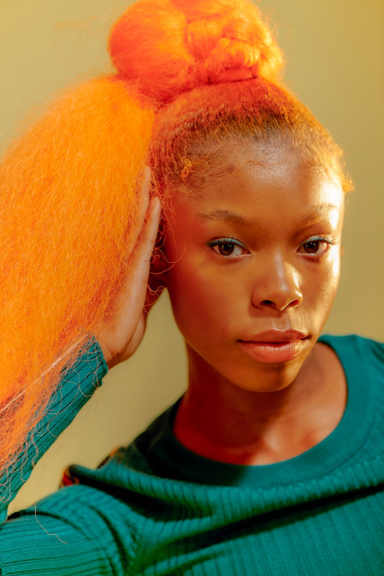 Intense young woman with orange hair and emotional Cancer qualities.