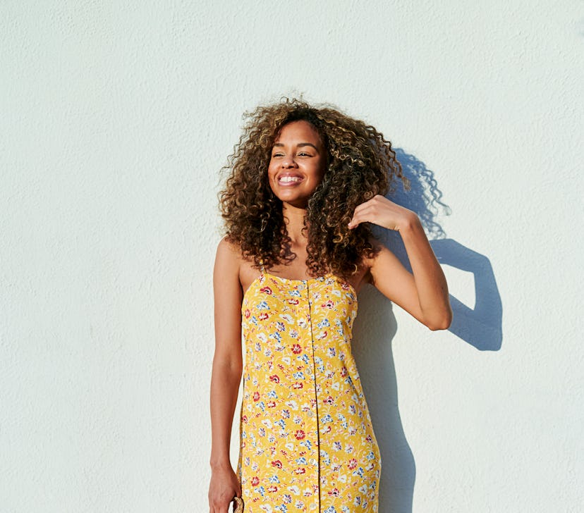 Young woman enjoying the sunlight ahead of Saturn retrograde 2022 on June 4, which will have a posit...