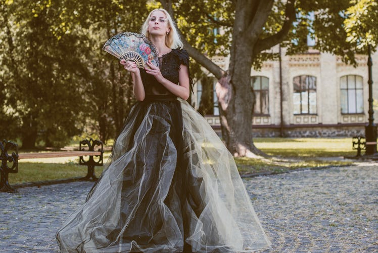 Halloween party concept, mysterious girl in black lace handmade dress . Beautiful young woman. Inspi...