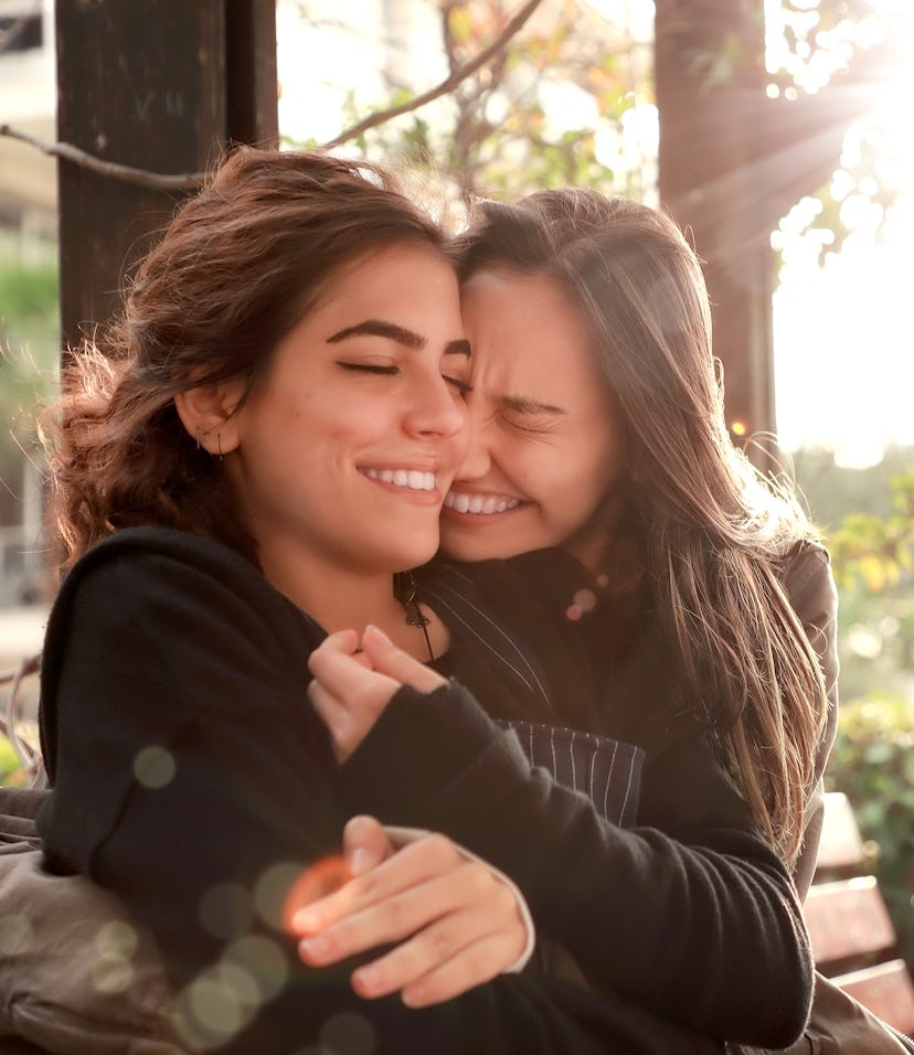 Two young women showing affection to symbolize the fifth house in astrology, aka the house of pleasu...