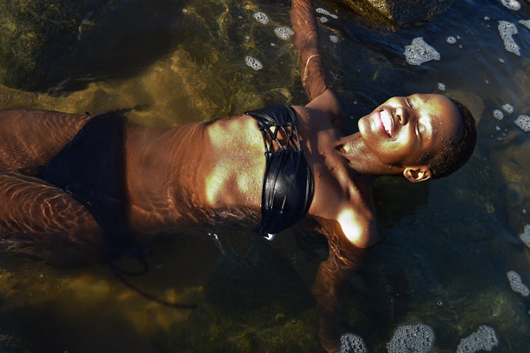 young beautiful black African female swimming at the beach