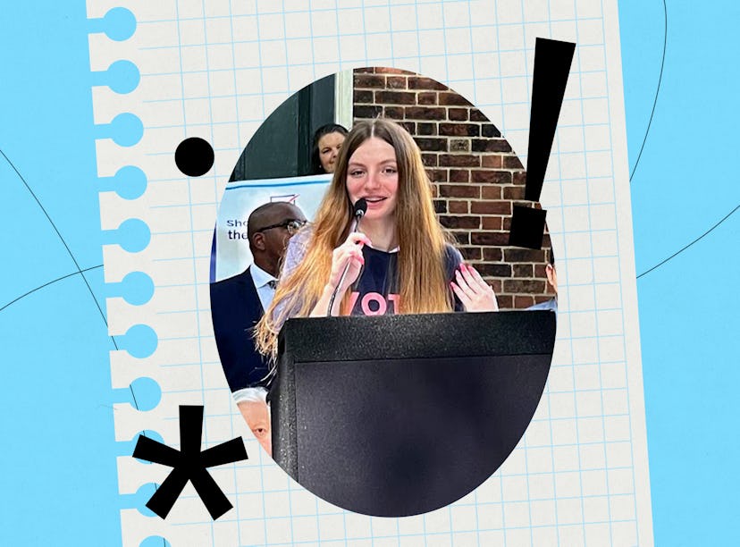 A young woman with long hair speaks into a microphone at a podium, passionately addressing an audien...