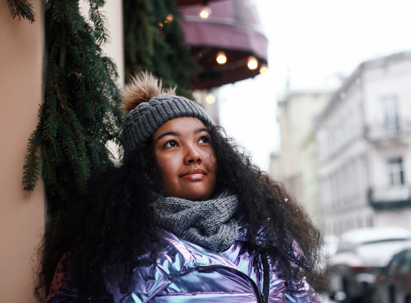 Young woman looking at snow outside during the December 2023 Cold Moon.