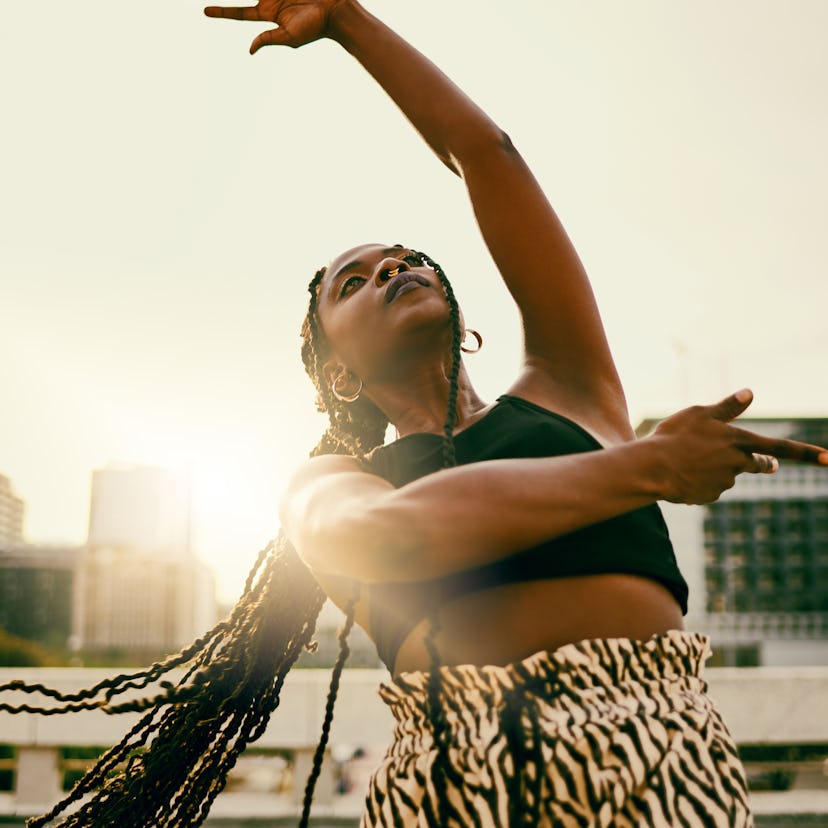 Young woman dancing because she's a Leo rising sign