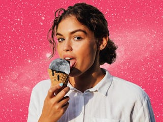 Young woman licking a moon ice cream before reading her August 2024 horoscope.